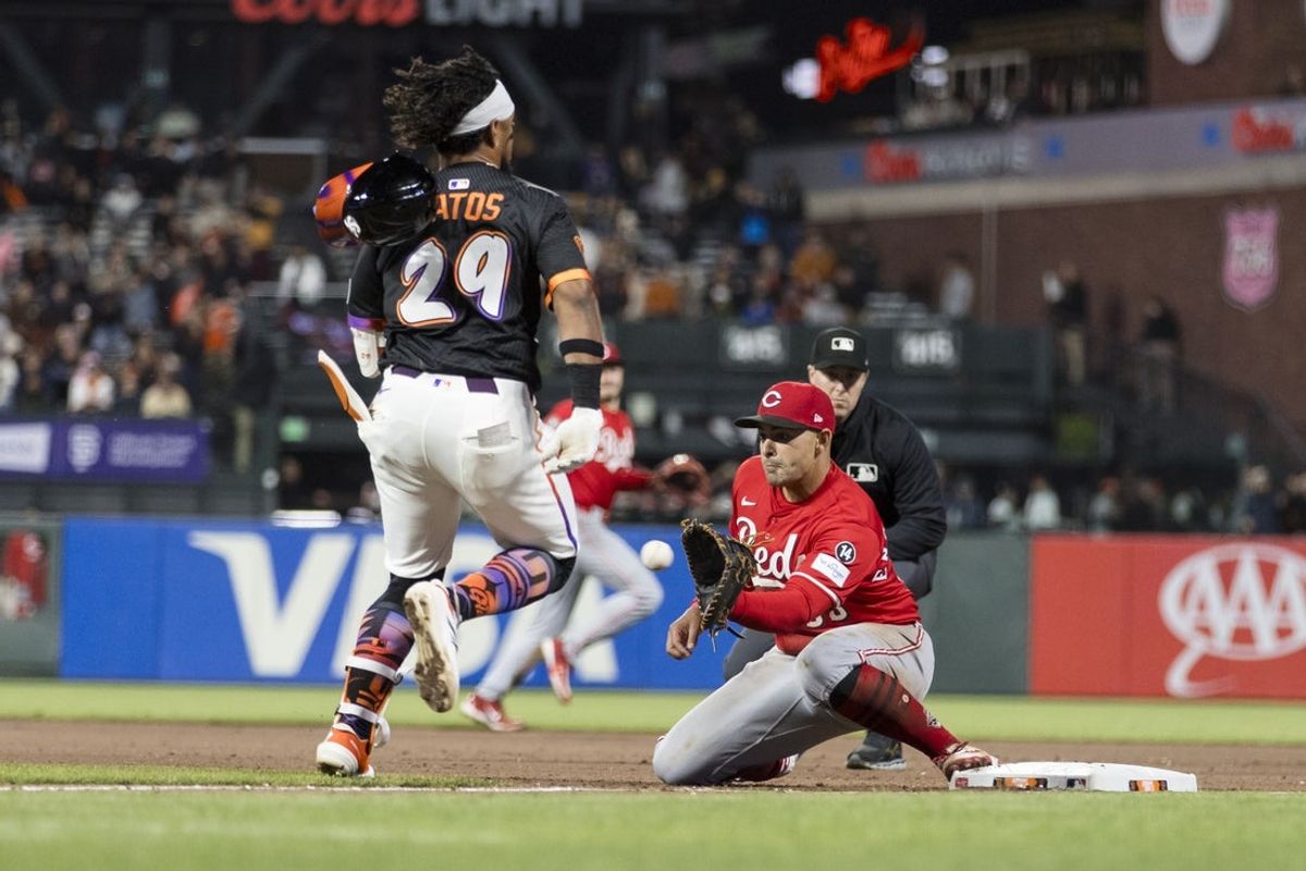 Apr 8, 2025; San Francisco, California, USA;  Cincinnati Reds first baseman Christian Encarnacion-Strand (33) tags San Francisco Giants right fielder Luis Matos (29) during the seventh inning at Oracle Park. Mandatory Credit: John Hefti-Imagn Images