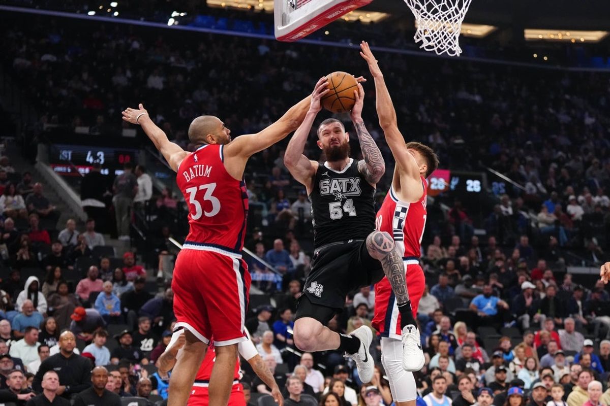 Apr 8, 2025; Inglewood, California, USA; San Antonio Spurs forward Sandro Mamukelashvili (54) shoots the ball against LA Clippers forward Nicolas Batum (33) and guard Bogdan Bogdanovic (10) in the first half at Intuit Dome. Mandatory Credit: Kirby Lee-Imagn Images