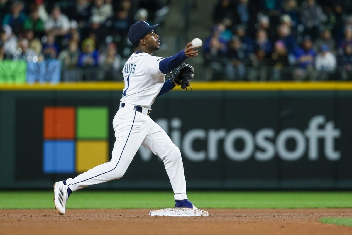 Apr 8, 2025; Seattle, Washington, USA; Seattle Mariners second baseman Ryan Bliss (1) turns a double play against the Houston Astros during the sixth inning at T-Mobile Park. Mandatory Credit: Joe Nicholson-Imagn Images