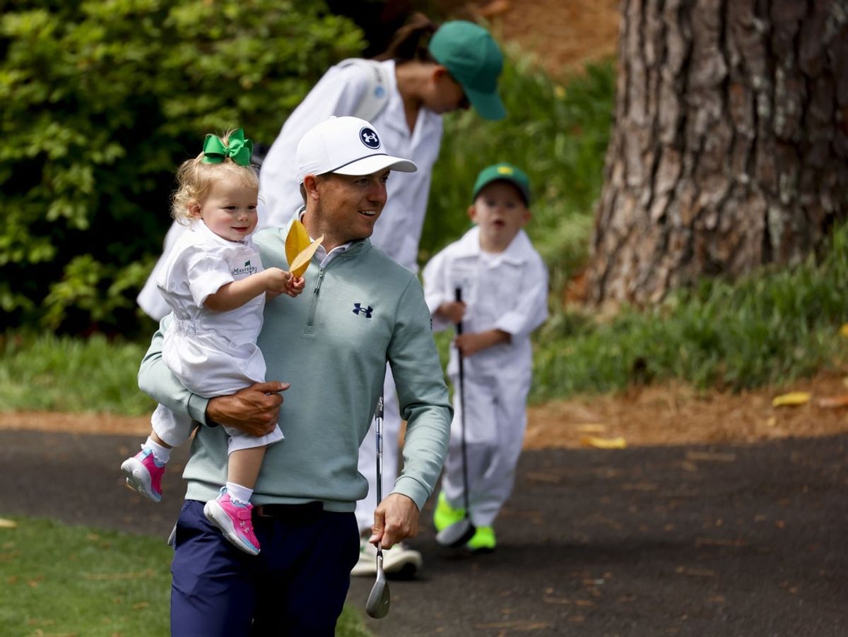 Apr 9, 2025; Augusta, Georgia, USA; Jordan Spieth holds his daughter, Sophie, while being followed by his wife, Annie, and son, Sammy, during the Par 3 Contest at Augusta National Golf Club. Mandatory Credit: Peter Casey-Imagn Images