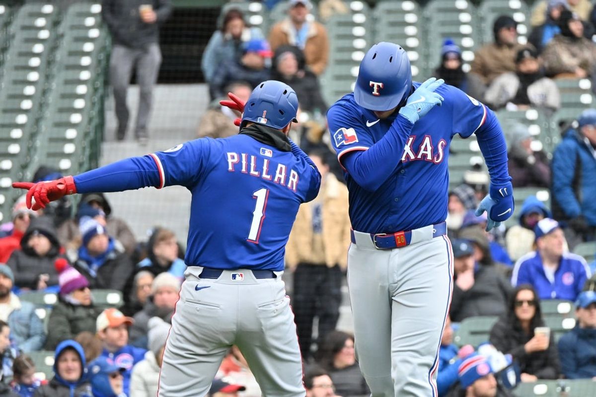 Apr 9, 2025; Chicago, Illinois, USA; Texas Rangers catcher Jonah Heim (right) celebrates his two run home run with left fielder Kevin Pillar (left) during the fifth inning against the Chicago Cubs at Wrigley Field. Mandatory Credit: Patrick Gorski-Imagn Images