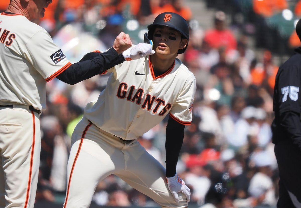 Apr 9, 2025; San Francisco, California, USA; San Francisco Giants center fielder Jung Hoo Lee (51) celebrates with third base coach Matt Williams (9) after hitting an RBI triple against the Cincinnati Reds during the fourth inning at Oracle Park. Mandatory Credit: Kelley L Cox-Imagn Images