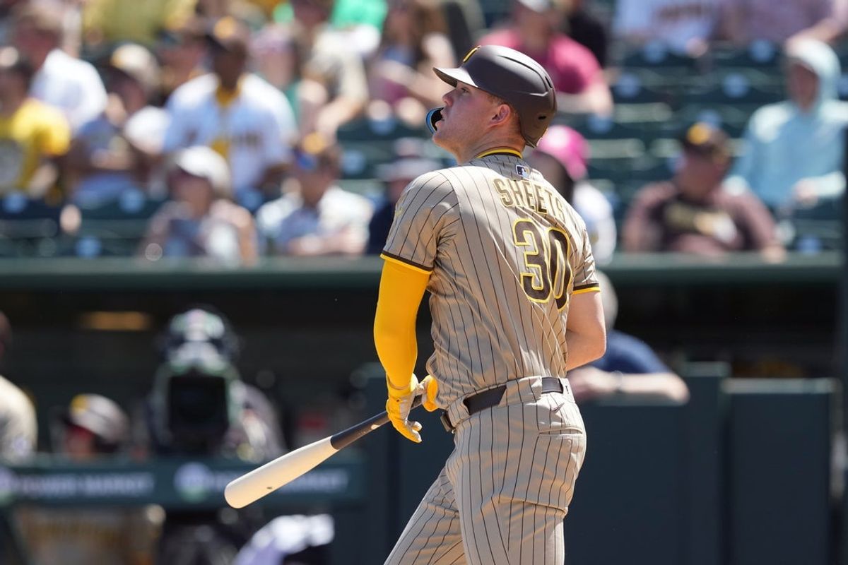 Apr 9, 2025; West Sacramento, California, USA; San Diego Padres designated hitter Gavin Sheets (30) hits an RBI sacrifice fly against the Athletics during the fifth inning at Sutter Health Park. Mandatory Credit: Darren Yamashita-Imagn Images