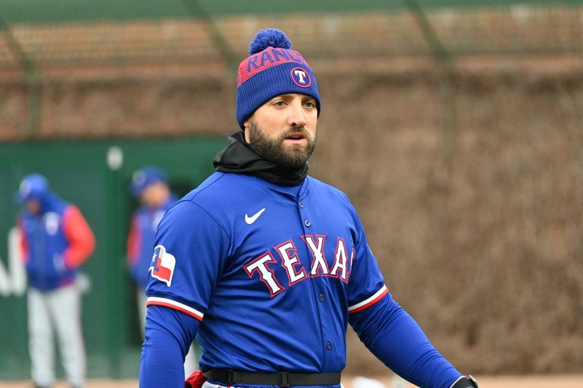 Apr 9, 2025; Chicago, Illinois, USA; Texas Rangers left fielder Kevin Pillar (1) is seen warming up prior to a game against the Chicago Cubs at Wrigley Field. Mandatory Credit: Patrick Gorski-Imagn Images