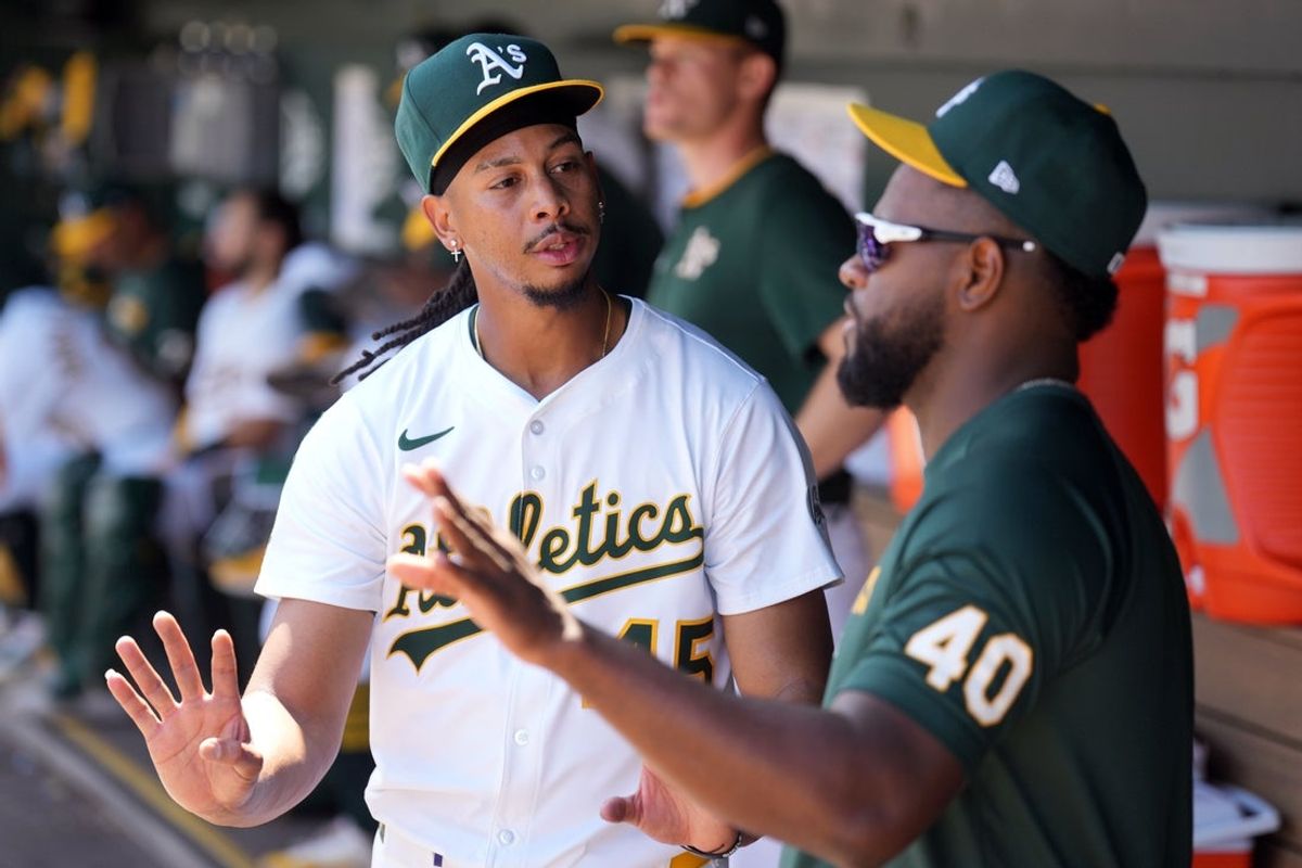 Apr 9, 2025; West Sacramento, California, USA; Athletics starting pitcher Osvaldo Bido (left) talks with pitcher Luis Severino (40) in the dugout during the fifth inning against the San Diego Padres at Sutter Health Park. Mandatory Credit: Darren Yamashita-Imagn Images
