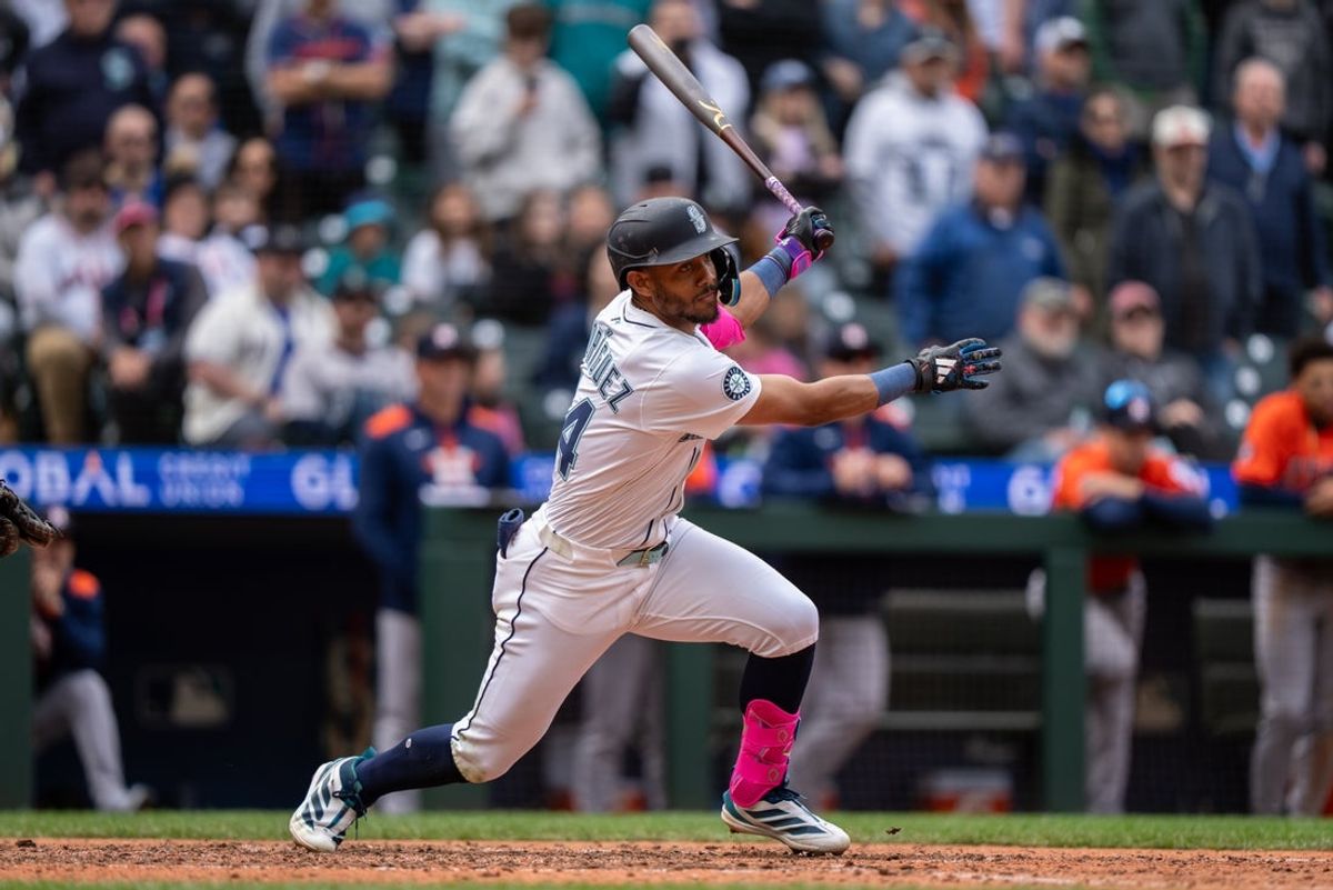 Apr 9, 2025; Seattle, Washington, USA;    Seattle Mariners centerfielder Julio Rodriguez (44) hits a two-run double during the ninth inning against the Houston Astros at T-Mobile Park. Mandatory Credit: Stephen Brashear-Imagn Images