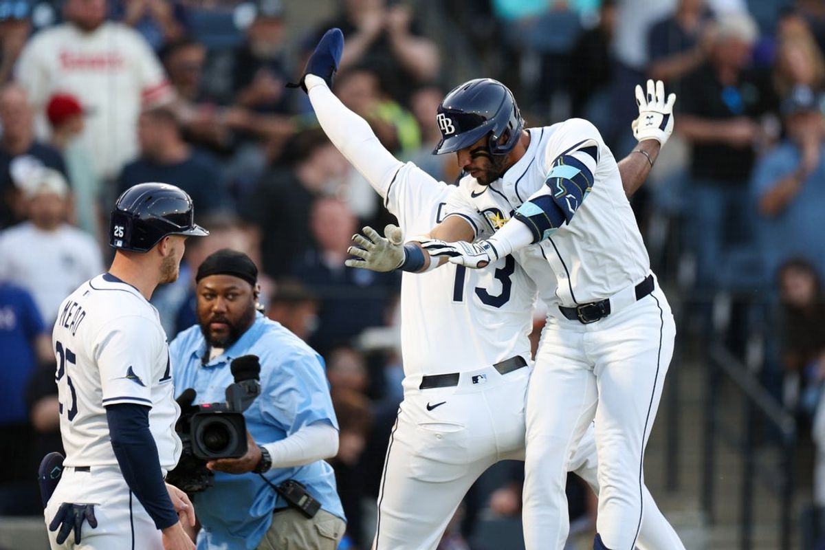 Apr 9, 2025; Anaheim, California, USA; Tampa Bay Rays right fielder Jose Caballero (77) celebrates with designated hitter Junior Caminero (13) after hitting a grans slam against the Los Angeles Angels in the first inning  at George M. Steinbrenner Field. Mandatory Credit: Nathan Ray Seebeck-Imagn Images
