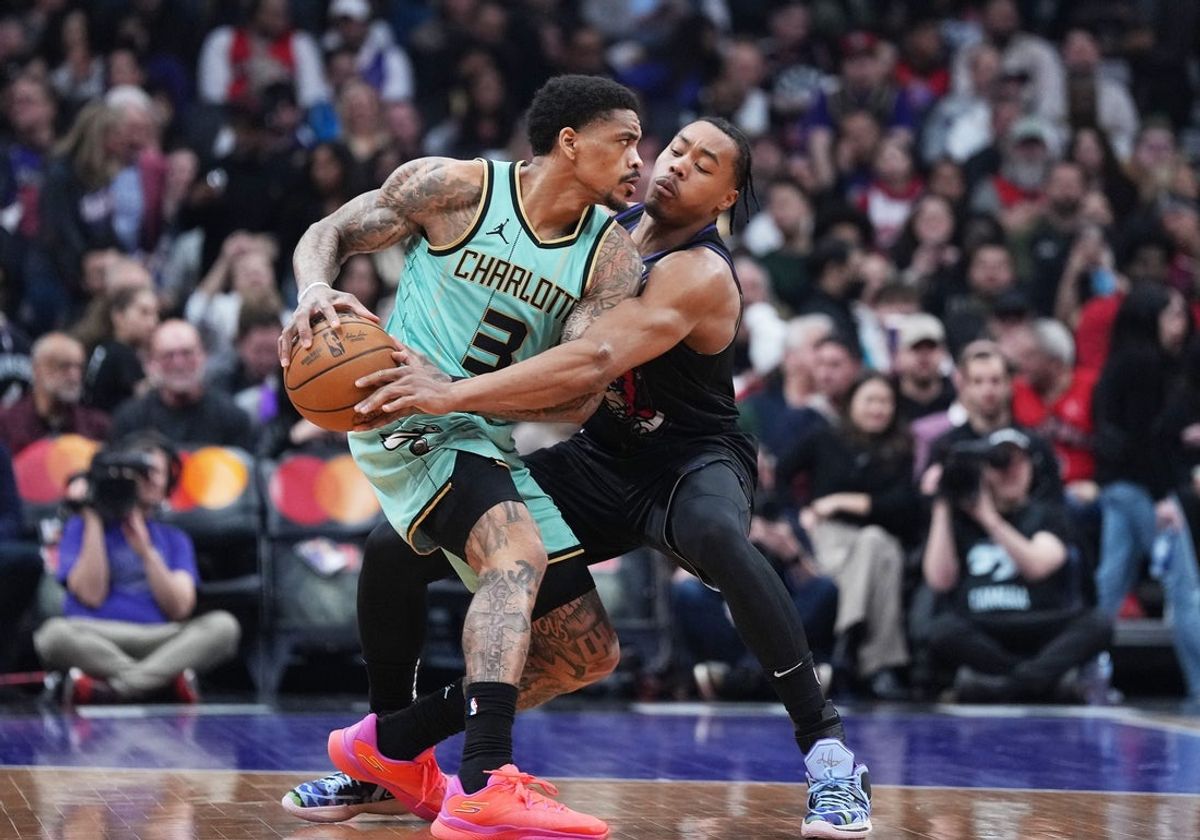 Apr 9, 2025; Toronto, Ontario, CAN; Toronto Raptors forward Scottie Barnes (4) battles for the ball with Charlotte Hornets guard DaQuan Jeffries (3) during the first quarter at Scotiabank Arena. Mandatory Credit: Nick Turchiaro-Imagn Images