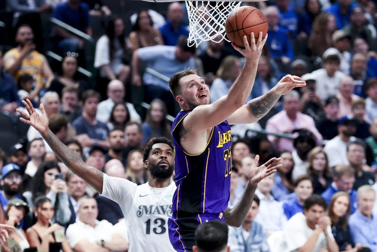 Apr 9, 2025; Dallas, Texas, USA;  Los Angeles Lakers guard Luka Doncic (77) shoots past Dallas Mavericks forward Naji Marshall (13) during the second quarter at American Airlines Center. Mandatory Credit: Kevin Jairaj-Imagn Images