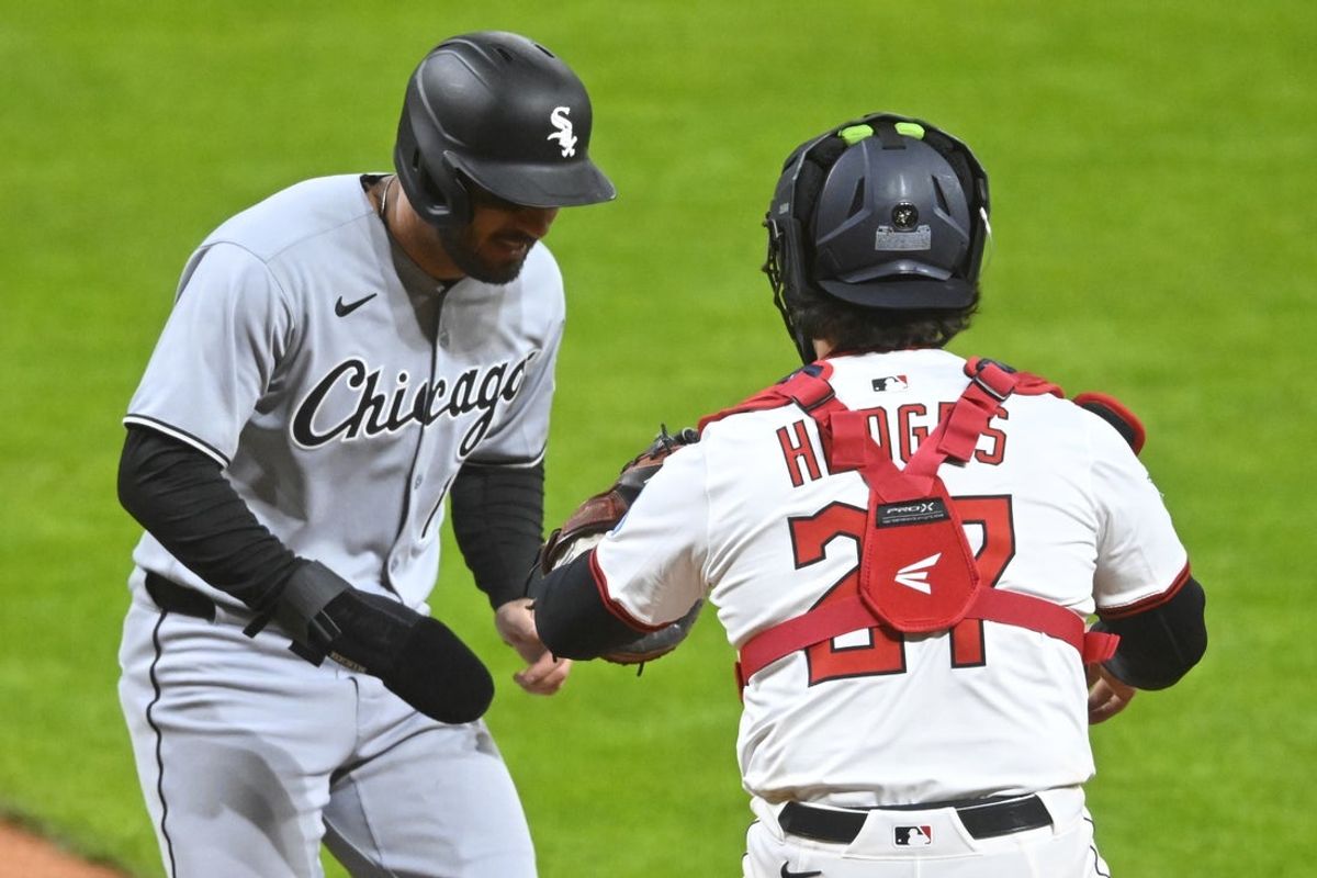 Apr 9, 2025; Cleveland, Ohio, USA; Cleveland Guardians catcher Austin Hedges (27) tags out Chicago White Sox right fielder Mike Tauchman (18) for the final out of the game in the ninth inning at Progressive Field. Mandatory Credit: David Richard-Imagn Images