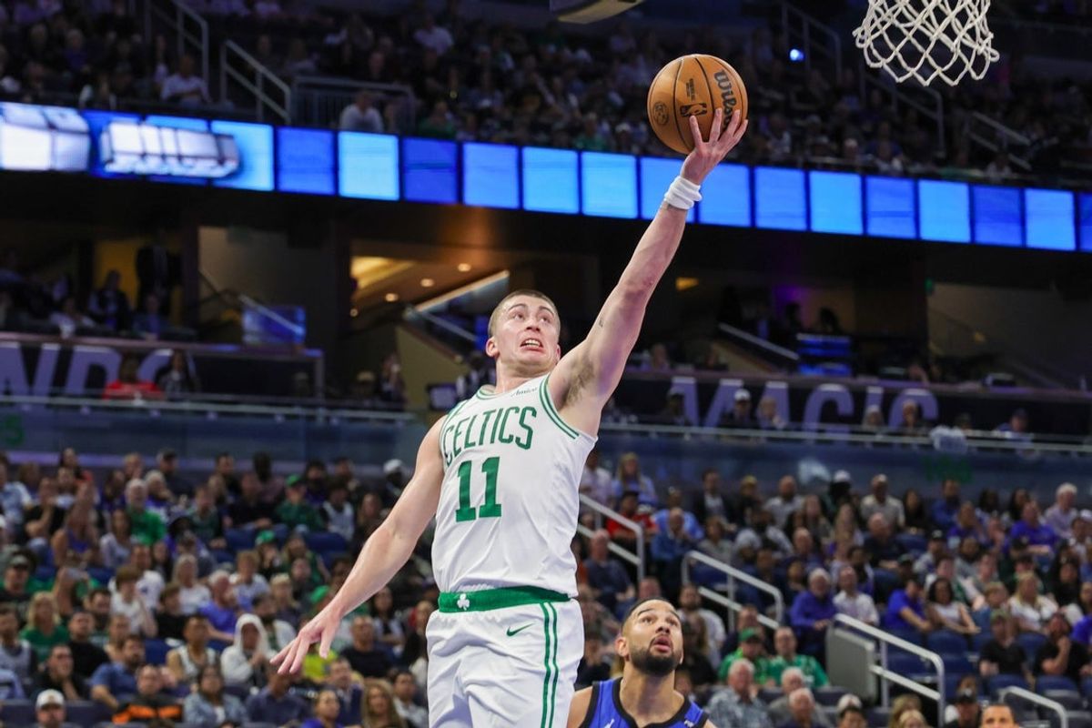 Apr 9, 2025; Orlando, Florida, USA; Boston Celtics guard Payton Pritchard (11) goes to the basket in front of Orlando Magic guard Cory Joseph (10) during the second quarter at Kia Center. Mandatory Credit: Mike Watters-Imagn Images