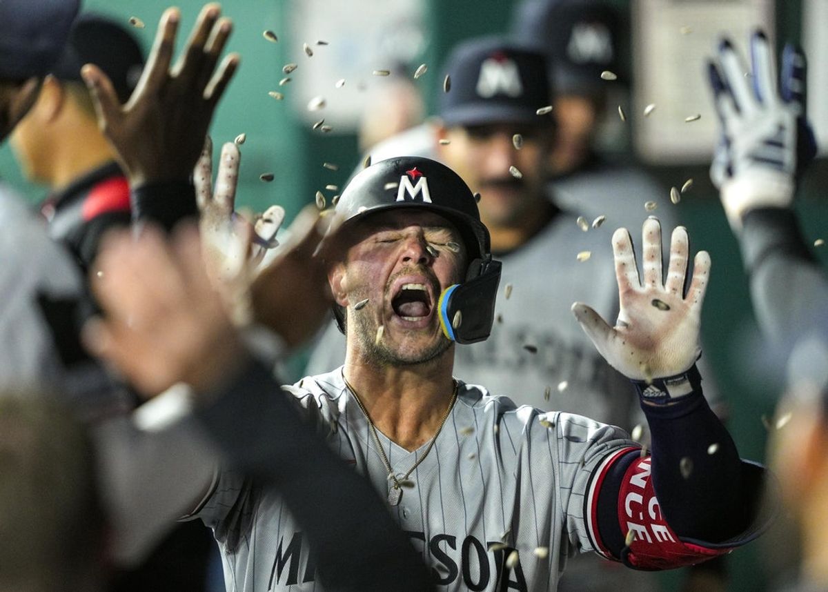 Apr 9, 2025; Kansas City, Missouri, USA; Minnesota Twins first baseman Ty France (13) is congratulated by teammates after hitting a home run during the ninth inning against the Kansas City Royals at Kauffman Stadium. Mandatory Credit: Jay Biggerstaff-Imagn Images