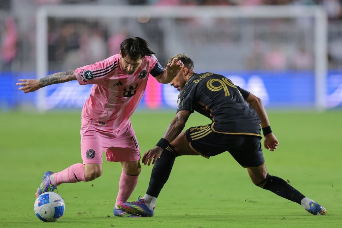 Apr 9, 2025; Ft. Lauderdale, Florida, USA; Inter Miami CF forward Lionel Messi (10) dribbles the ball past Los Angeles FC forward Denis Bouanga (99) during the second half at Chase Stadium. Mandatory Credit: Sam Navarro-Imagn Images