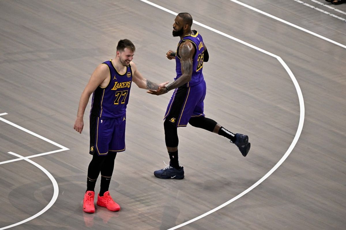 Apr 9, 2025; Dallas, Texas, USA; Los Angeles Lakers guard Luka Doncic (77) and Lakers forward LeBron James (23) celebrate during the fourth quarter against the Dallas Mavericks at the American Airlines Center. Mandatory Credit: Jerome Miron-Imagn Images
