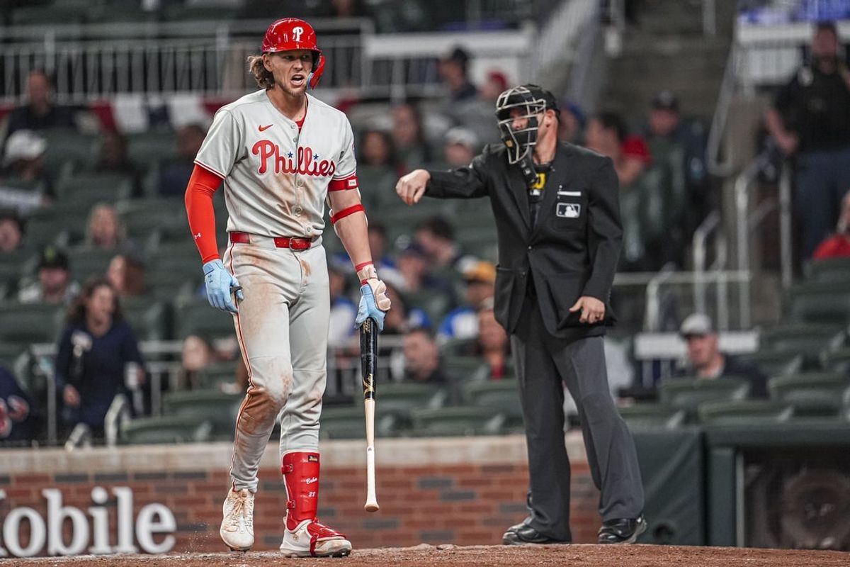 Apr 9, 2025; Cumberland, Georgia, USA; Philadelphia Phillies third base Alec Bohm (28) reacts after being called out on strikes against the Atlanta Braves during the ninth inning at Truist Park. Mandatory Credit: Dale Zanine-Imagn Images