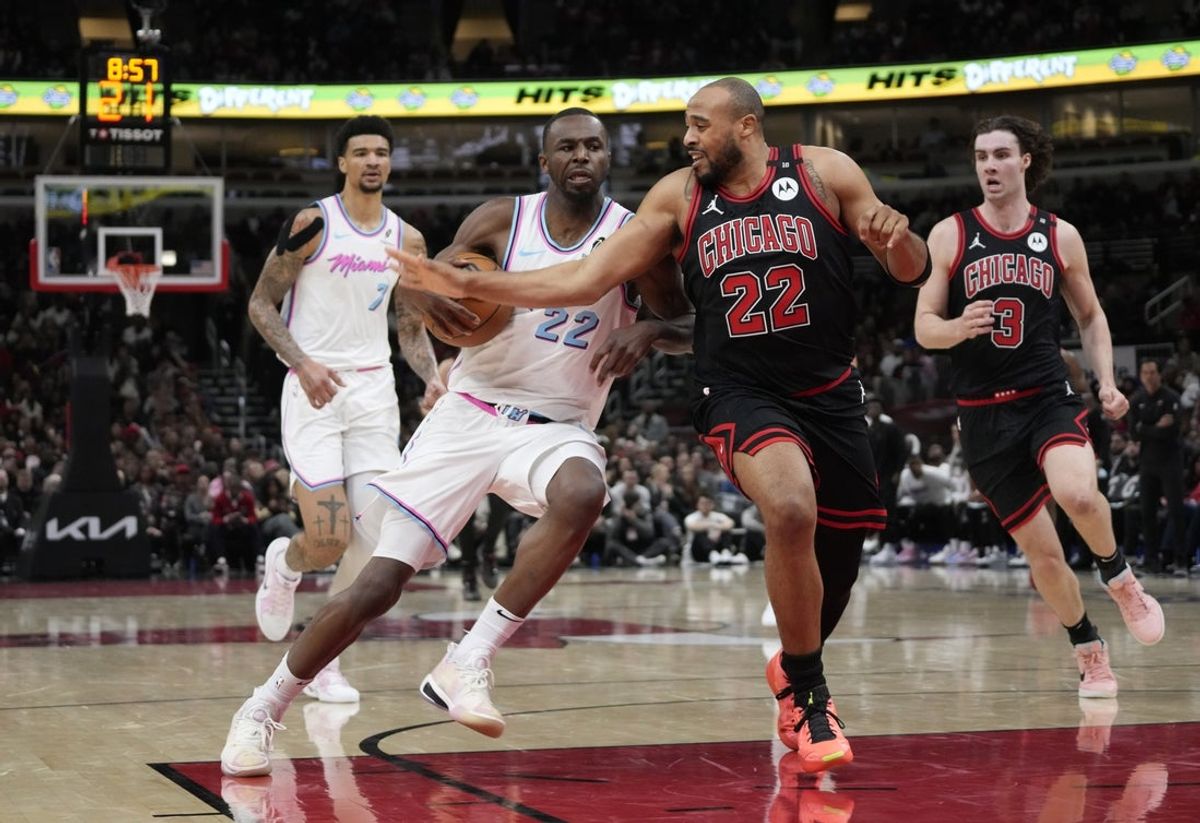Apr 9, 2025; Chicago, Illinois, USA; Chicago Bulls forward Talen Horton-Tucker (22) defends Miami Heat forward Andrew Wiggins (22) during the second half at United Center. Mandatory Credit: David Banks-Imagn Images
