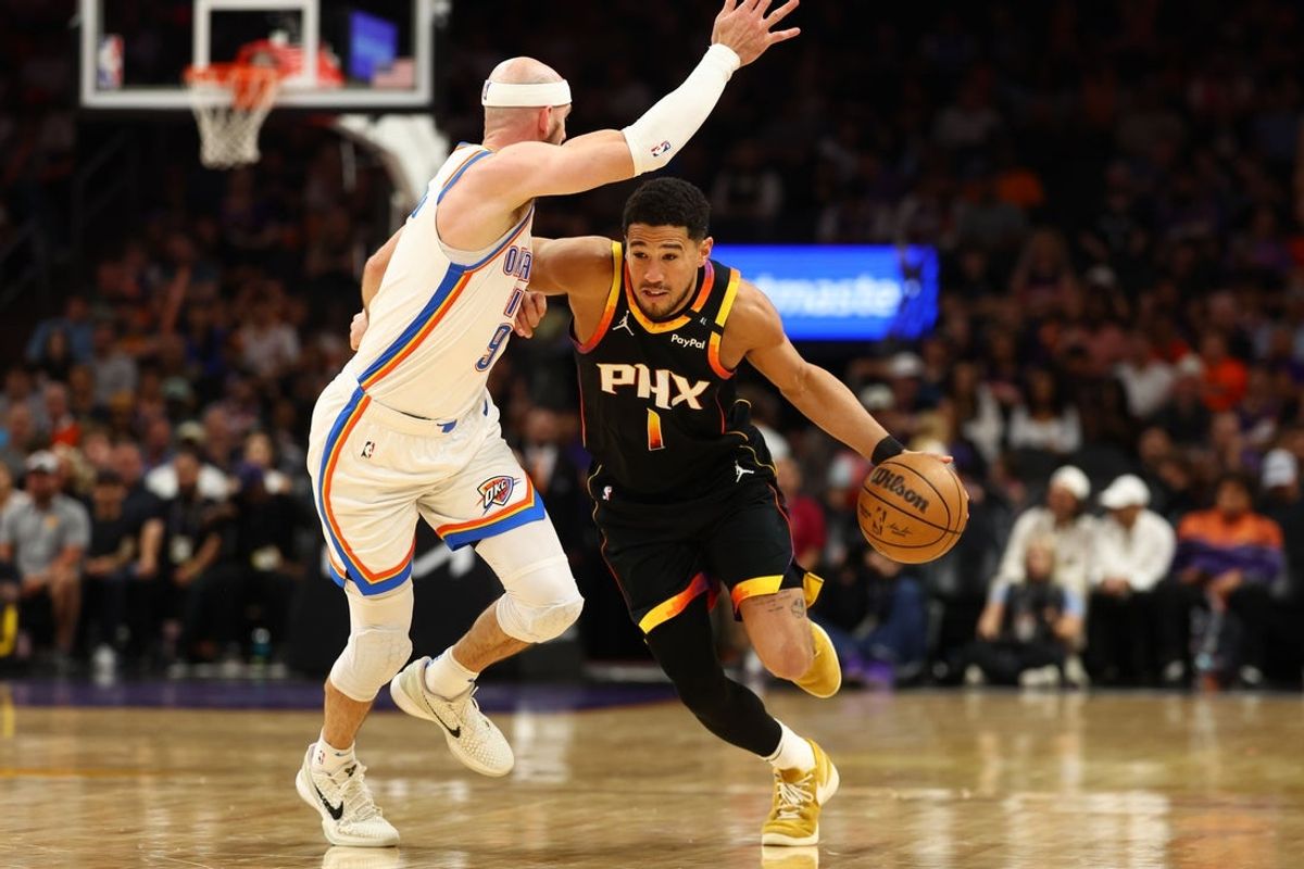 Apr 9, 2025; Phoenix, Arizona, USA; Phoenix Suns guard Devin Booker (1) dribbles the ball against  Oklahoma City Thunder guard Alex Caruso (9) during the first half at Footprint Center. Mandatory Credit: Mark J. Rebilas-Imagn Images