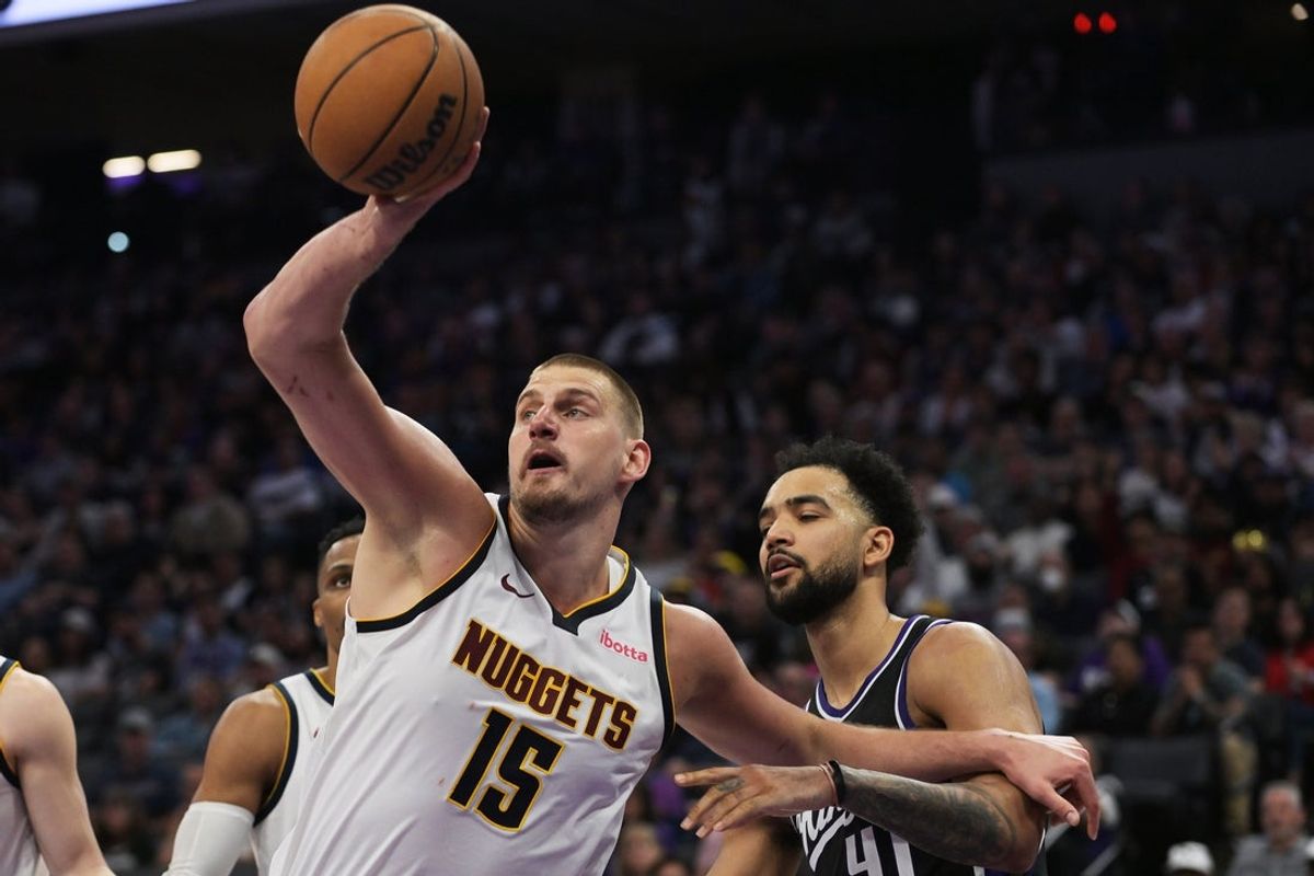 Apr 9, 2025; Sacramento, California, USA; Denver Nuggets center Nikola Jokic (15) rebounds the ball against Sacramento Kings forward Trey Lyles (41) during the third quarter at Golden 1 Center. Mandatory Credit: Ed Szczepanski-Imagn Images