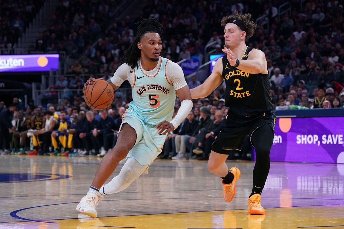 Apr 9, 2025; San Francisco, California, USA;  San Antonio Spurs guard Stephon Castle (5) dribbles against Golden State Warriors guard Brandin Podziemski (2) in the fourth quarter at Chase Center. Mandatory Credit: David Gonzales-Imagn Images