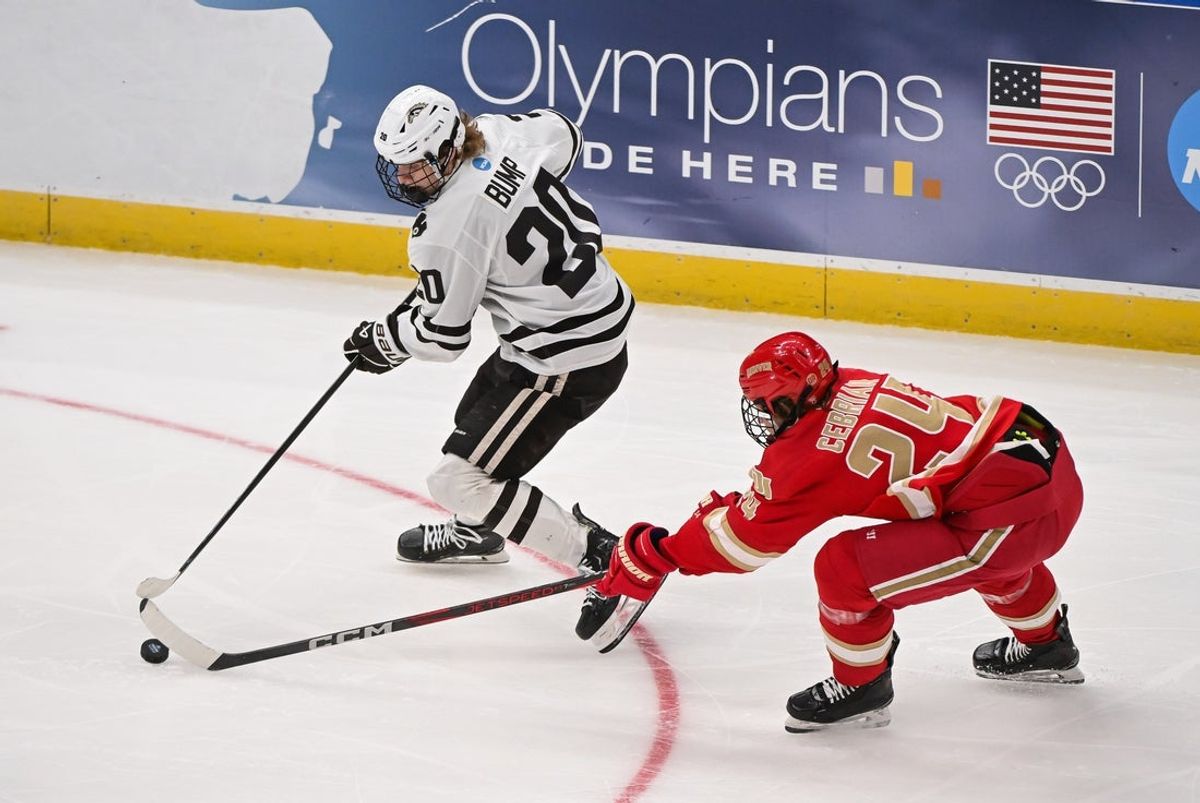 Apr 10, 2025; St. Louis, Missouri, UNITED STATES; Denver Pioneers forward Kieran Cebrian (24) and Western Michigan Broncos forward Alex Bump (20) battle for control of the puck during the first period of the Frozen Four college ice hockey national semifinals at Enterprise Center. Mandatory Credit: Connor Hamilton-Imagn Images