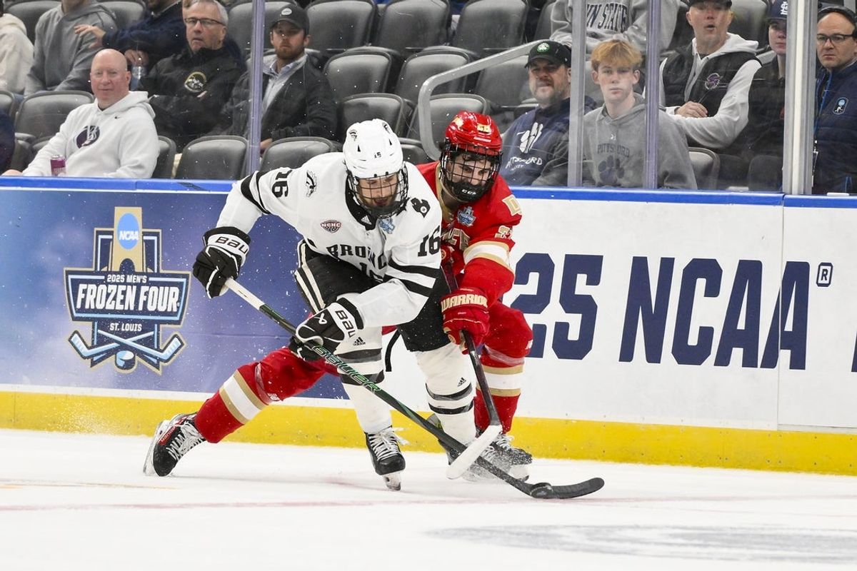 Apr 10, 2025; St. Louis, Missouri, UNITED STATES; Western Michigan Broncos forward Tim Washe (16) and Denver Pioneers defenseman Zeev Buium (28) battle for the puck during the second period of the Frozen Four college ice hockey national semifinals at Enterprise Center. Mandatory Credit: Jeff Curry-Imagn Images