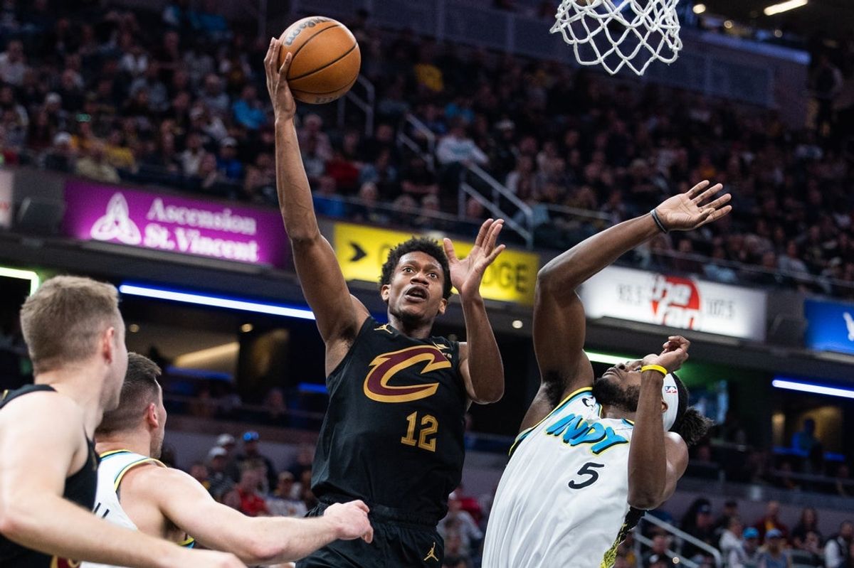Apr 10, 2025; Indianapolis, Indiana, USA; Cleveland Cavaliers forward De'Andre Hunter (12) shoots the ball while Indiana Pacers center Thomas Bryant (3) defends in the first half at Gainbridge Fieldhouse. Mandatory Credit: Trevor Ruszkowski-Imagn Images