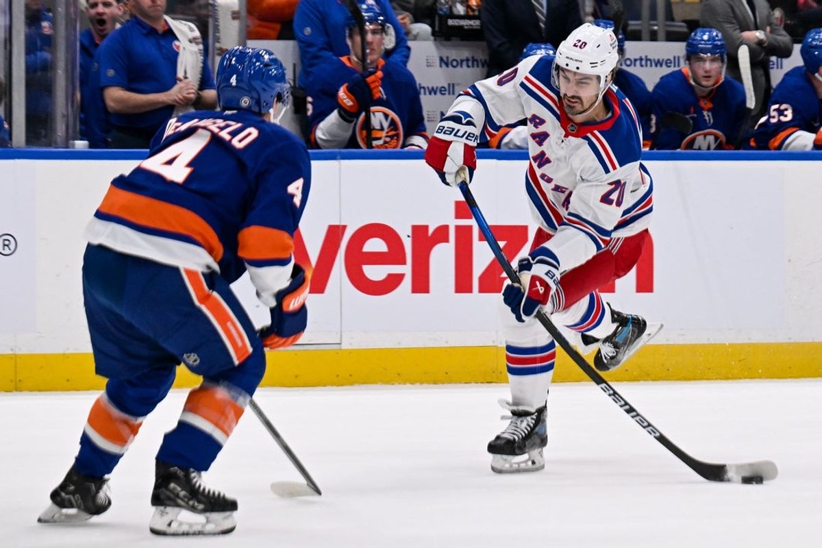 Apr 10, 2025; Elmont, New York, USA;  New York Rangers left wing Chris Kreider (20) attempts a shot defended by New York Islanders defenseman Tony DeAngelo (4) during the first period at UBS Arena. Mandatory Credit: Dennis Schneidler-Imagn Images