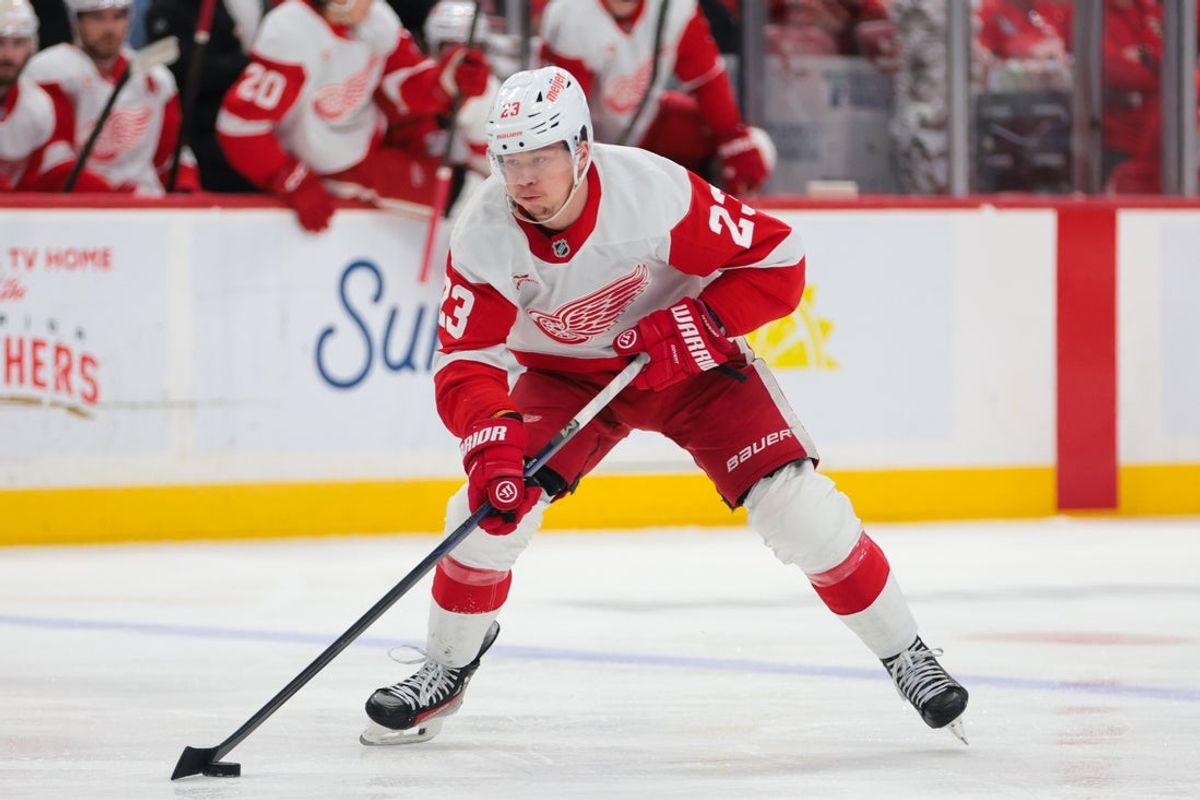 Apr 10, 2025; Sunrise, Florida, USA; Detroit Red Wings left wing Lucas Raymond (23) moves the puck against the Florida Panthers during the second period at Amerant Bank Arena. Mandatory Credit: Sam Navarro-Imagn Images