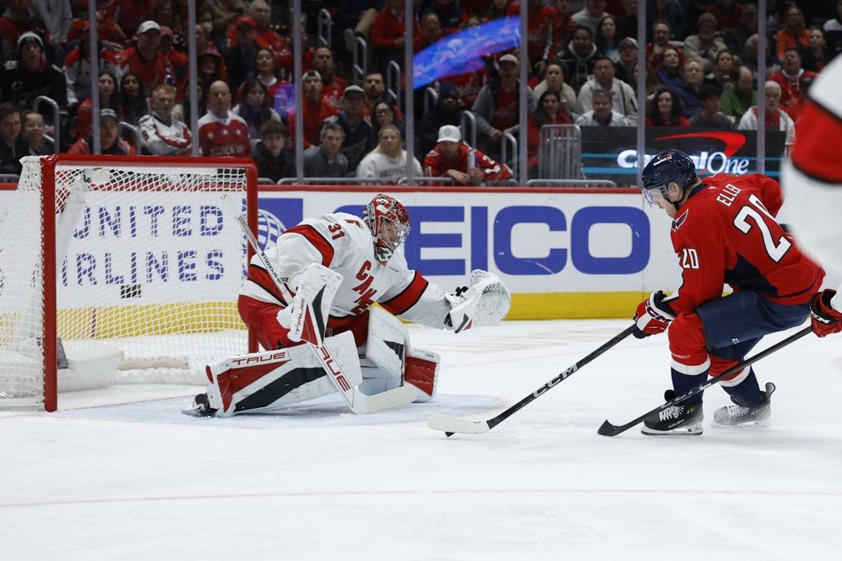Apr 10, 2025; Washington, District of Columbia, USA; Carolina Hurricanes goaltender Frederik Andersen (31) makes a save on Washington Capitals center Lars Eller (20) in the first period at Capital One Arena. Mandatory Credit: Geoff Burke-Imagn Images