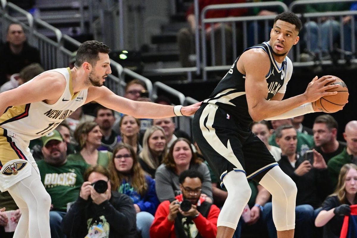 Apr 10, 2025; Milwaukee, Wisconsin, USA; Milwaukee Bucks forward Giannis Antetokounmpo (34) looks for a shot against New Orleans Pelicans forward Karlo Matkovic (17) in the first quarter at Fiserv Forum. Mandatory Credit: Benny Sieu-Imagn Images