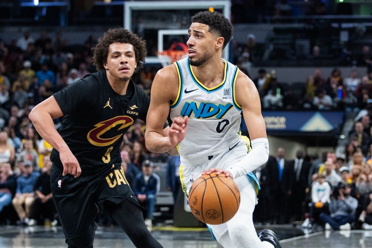 Apr 10, 2025; Indianapolis, Indiana, USA; Indiana Pacers guard Tyrese Haliburton (0) dribbles the ball while Cleveland Cavaliers guard Craig Porter Jr. (9) defends in the second half at Gainbridge Fieldhouse. Mandatory Credit: Trevor Ruszkowski-Imagn Images