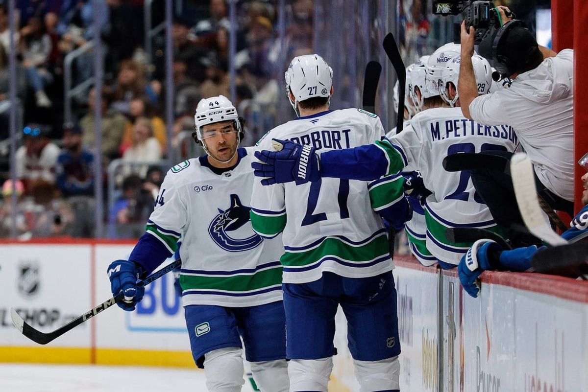 Apr 10, 2025; Denver, Colorado, USA; Vancouver Canucks left wing Kiefer Sherwood (44) celebrates with the bench after his goal in the second period against the Colorado Avalanche at Ball Arena. Mandatory Credit: Isaiah J. Downing-Imagn Images