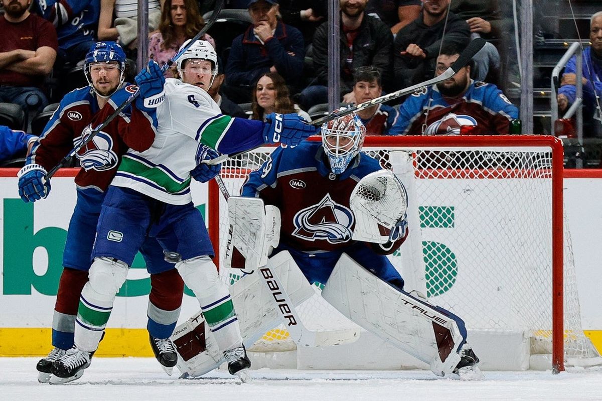 Apr 10, 2025; Denver, Colorado, USA; Vancouver Canucks right wing Brock Boeser (6) looks to redirect a puck against Colorado Avalanche goaltender Mackenzie Blackwood (39) as defenseman Samuel Girard (49) defends in the second period at Ball Arena. Mandatory Credit: Isaiah J. Downing-Imagn Images