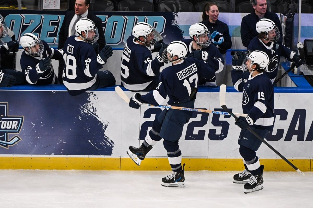 Apr 10, 2025; St. Louis, Missouri, UNITED STATES; Penn State Nittany Lions forward Nicholas DeGraves (17) celebrates with teammates after scoring a goal against the Boston University Terriers during the third period of the Frozen Four college ice hockey national semifinals at Enterprise Center. Mandatory Credit: Connor Hamilton-Imagn Images