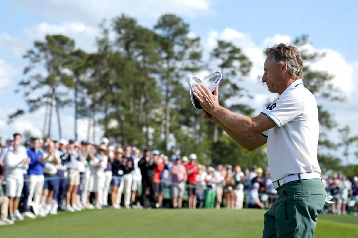 Apr 11, 2025; Augusta, Georgia, USA; Bernhard Langer waves to patrons as he walks off no. 18 during the second round of the Masters Tournament at Augusta National Golf Club. Mandatory Credit: Katie Goodale-Imagn Images