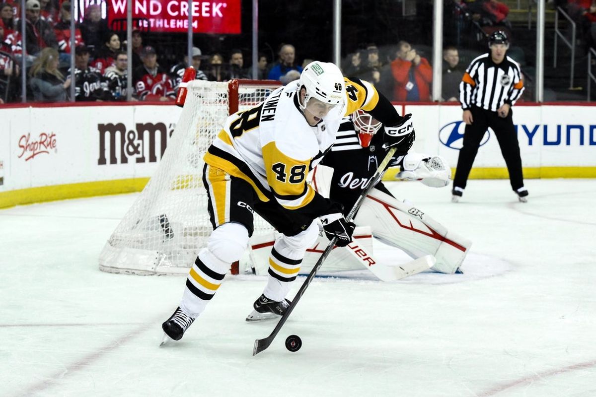 Apr 11, 2025; Newark, New Jersey, USA; Pittsburgh Penguins right wing Valtteri Puustinen (48) controls the puck against the New Jersey Devils during the first period at Prudential Center. Mandatory Credit: John Jones-Imagn Images