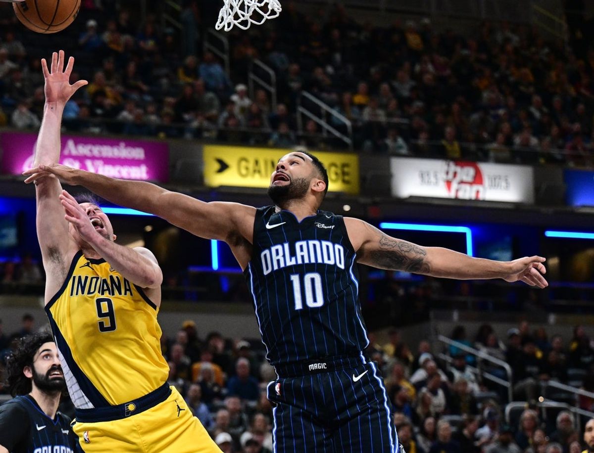 Apr 11, 2025; Indianapolis, Indiana, USA; Indiana Pacers guard T.J. McConnell (9) shoots the ball past Orlando Magic guard Cory Joseph (10) during the first quarter at Gainbridge Fieldhouse. Mandatory Credit: Marc Lebryk-Imagn Images