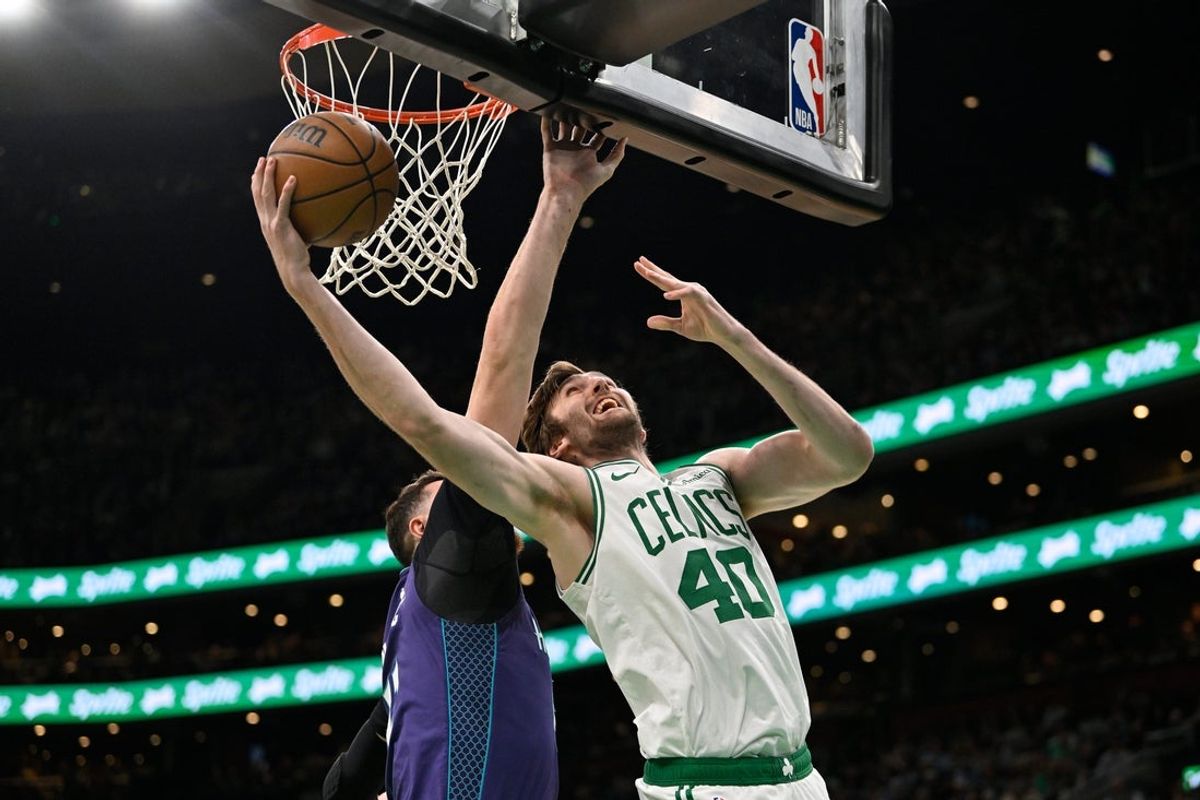 Apr 11, 2025; Boston, Massachusetts, USA; Boston Celtics center Luke Kornet (40) shoots the ball against Charlotte Hornets center Jusuf Nurkic (11) during the first half at TD Garden. Mandatory Credit: Eric Canha-Imagn Images