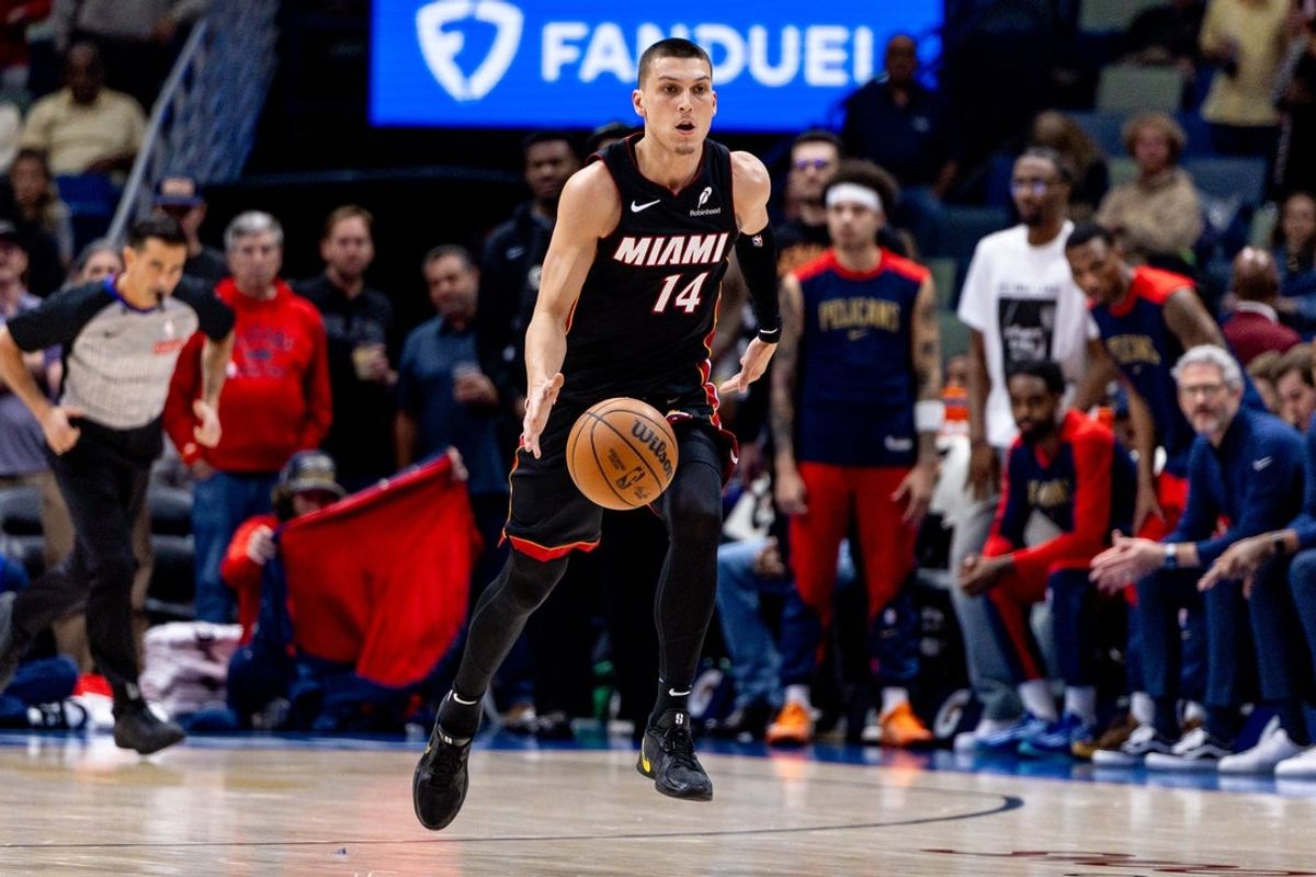 Apr 11, 2025; New Orleans, Louisiana, USA;  Miami Heat guard Tyler Herro (14) brings the ball up court against the New Orleans Pelicans during the first half at Smoothie King Center. Mandatory Credit: Stephen Lew-Imagn Images
