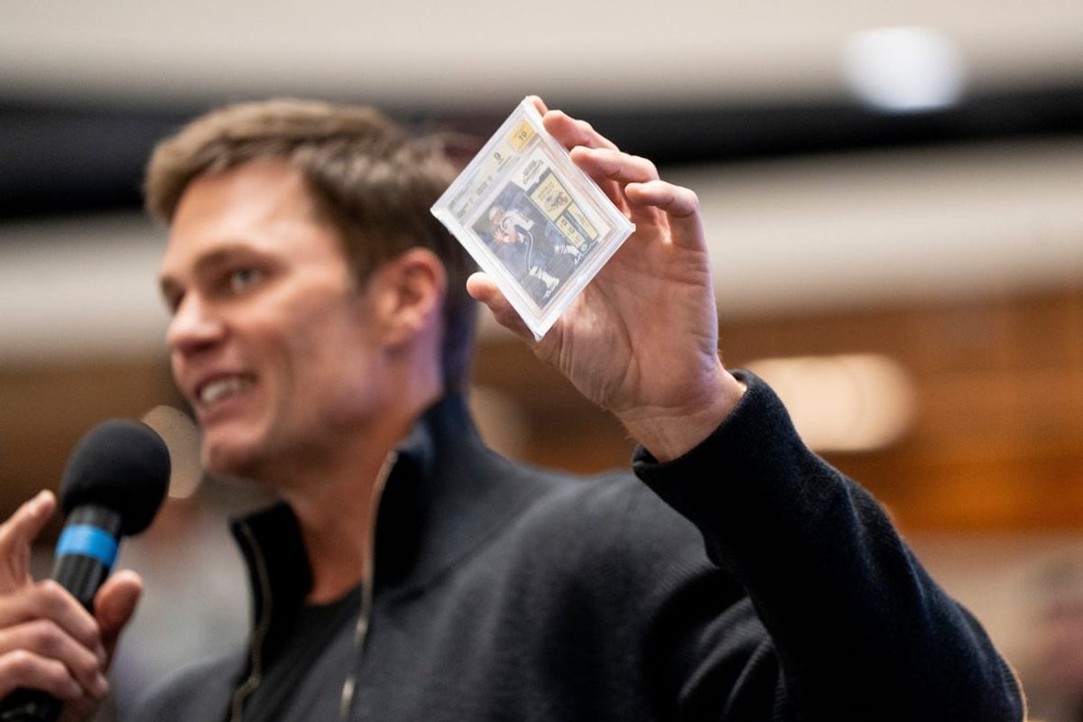 Tom Brady holds a card at American Dream for the grand opening of Card Vault by Tom Brady, a sports card and memorabilia retailer, East Rutherford, Friday, Apr. 11, 2025.