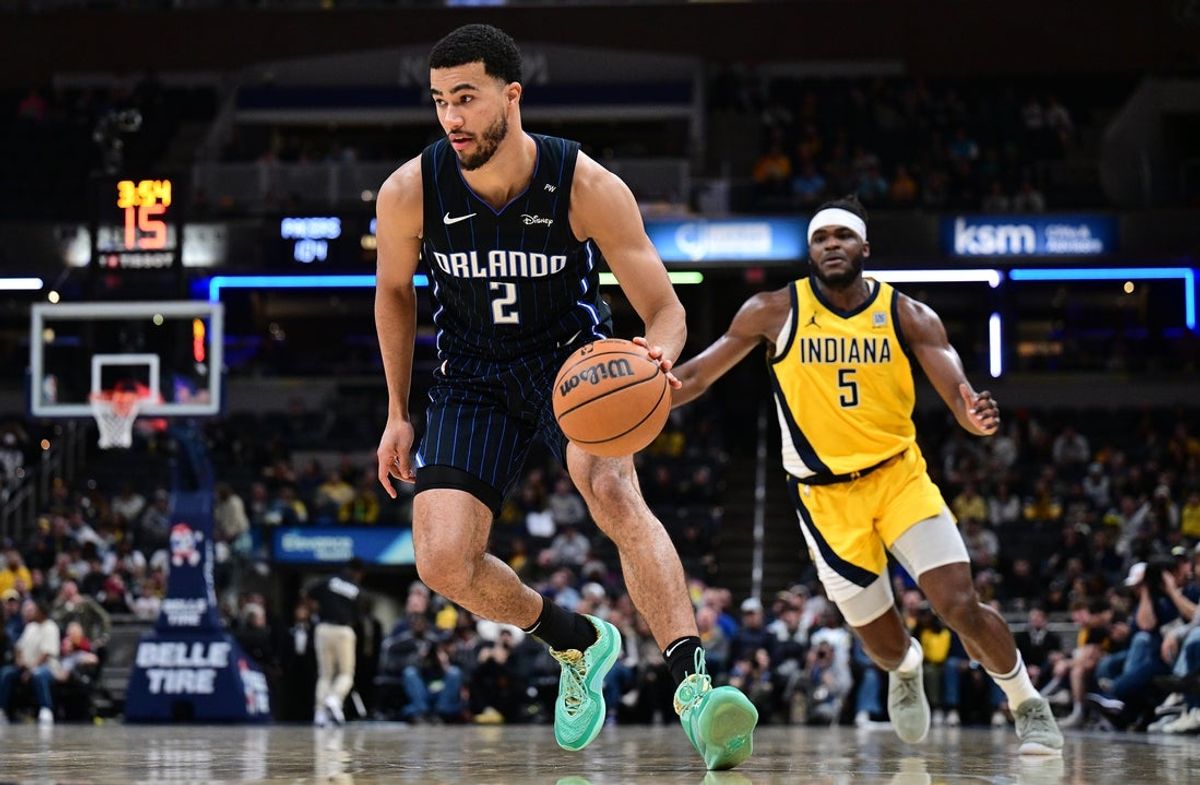 Apr 11, 2025; Indianapolis, Indiana, USA; Orlando Magic guard Caleb Houstan (2) drives the ball past Indiana Pacers forward Jarace Walker (5) during the second half at Gainbridge Fieldhouse. Mandatory Credit: Marc Lebryk-Imagn Images