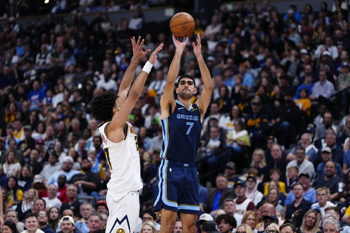 Apr 11, 2025; Denver, Colorado, USA; Denver Nuggets guard Jamal Murray (27) defends Memphis Grizzlies forward Santi Aldama (7) in the first quarter at Ball Arena. Mandatory Credit: Ron Chenoy-Imagn Images