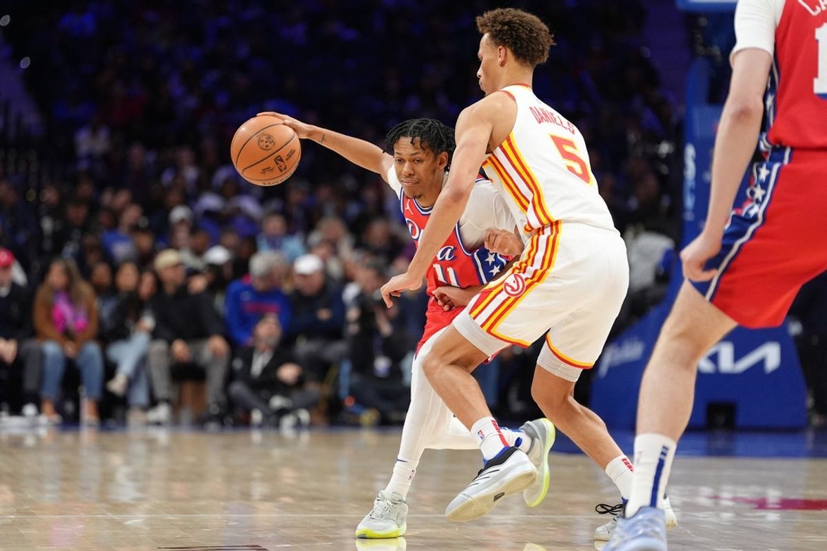Apr 11, 2025; Philadelphia, Pennsylvania, USA; Philadelphia 76ers guard Jeff Dowtin Jr (11) drives against Atlanta Hawks guard Dyson Daniels (5) in the fourth quarter at Wells Fargo Center. Mandatory Credit: Kyle Ross-Imagn Images