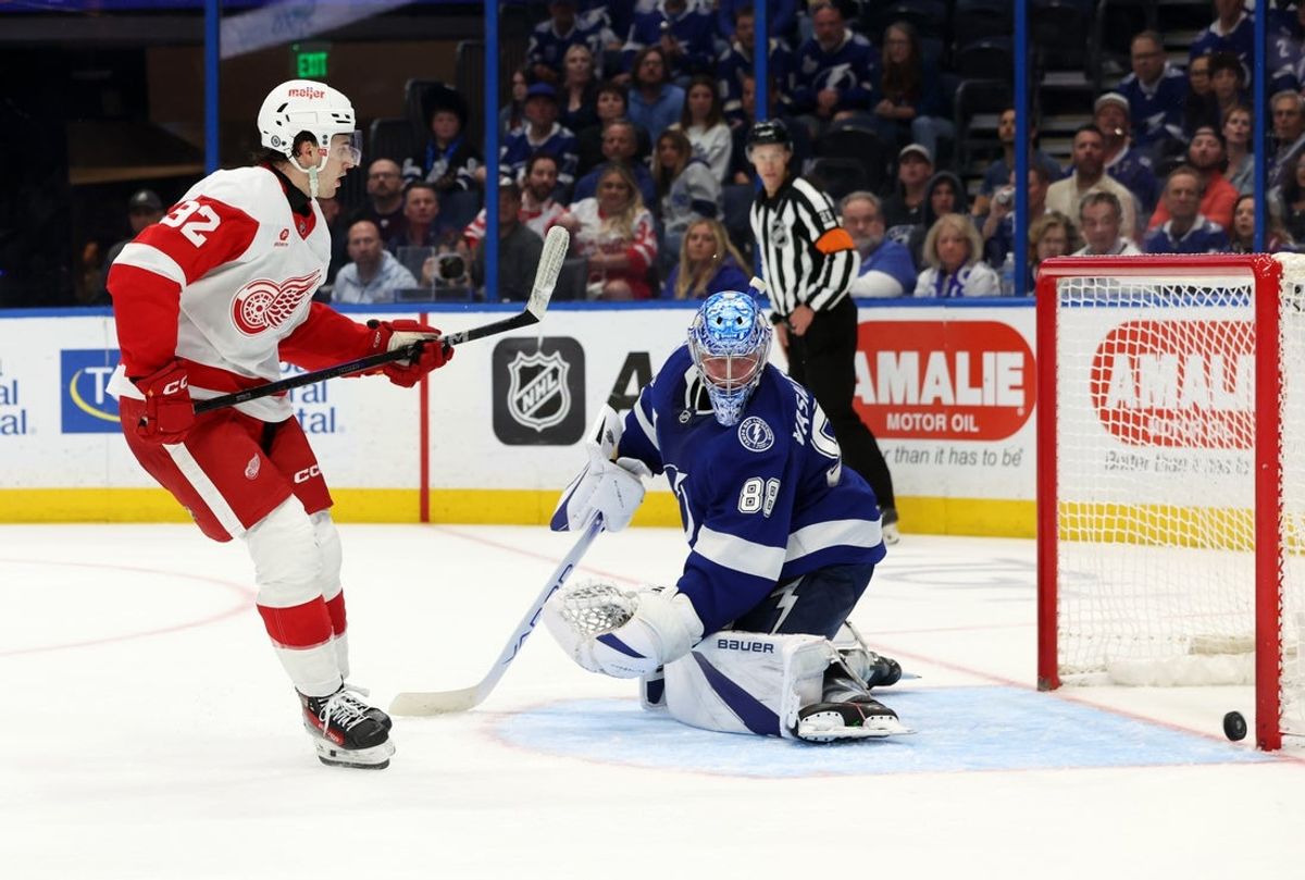 Apr 11, 2025; Tampa, Florida, USA; Detroit Red Wings right wing Alex DeBrincat (93) shoots and scores the game winning goal on Tampa Bay Lightning goaltender Andrei Vasilevskiy (88) during overtime at Amalie Arena. Mandatory Credit: Kim Klement Neitzel-Imagn Images