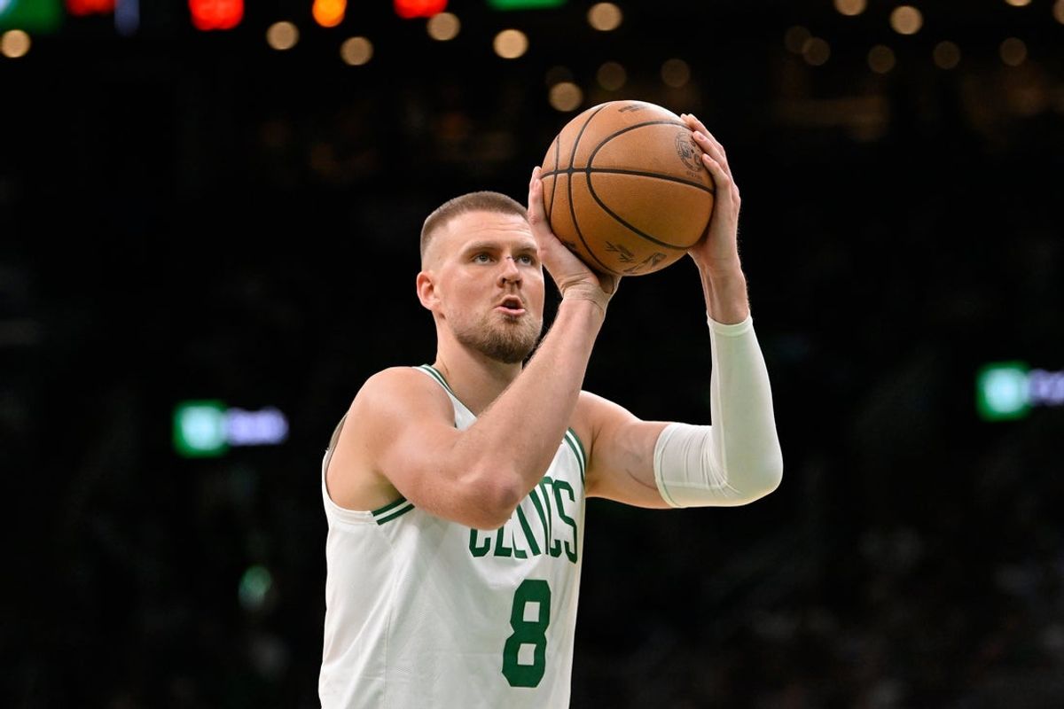 Apr 11, 2025; Boston, Massachusetts, USA; Boston Celtics center Kristaps Porzingis (8) shoots a free throw during the first half against the Charlotte Hornets at TD Garden. Mandatory Credit: Eric Canha-Imagn Images