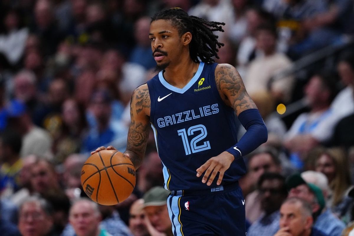 Apr 11, 2025; Denver, Colorado, USA; Memphis Grizzlies guard Ja Morant (12) controls the ball in the second quarter against the Denver Nuggets at Ball Arena. Mandatory Credit: Ron Chenoy-Imagn Images
