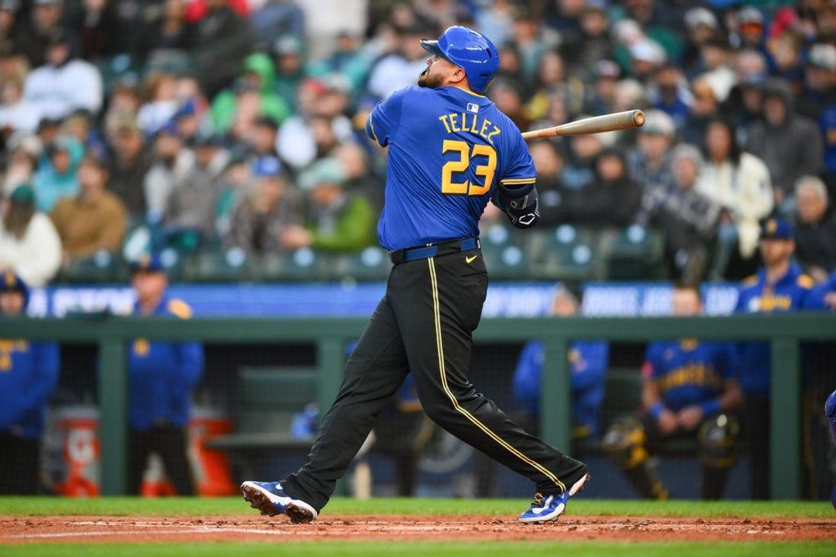 Apr 11, 2025; Seattle, Washington, USA; Seattle Mariners first baseman Rowdy Tellez (23) hits a home run against the Texas Rangers during the second inning at T-Mobile Park. Mandatory Credit: Steven Bisig-Imagn Images