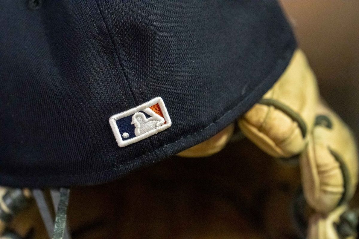 Apr 11, 2025; Minneapolis, Minnesota, USA; A general view of a Detroit Tigers hat with the Major League Baseball logo sitting in the dugout in a game against the Minnesota Twins at Target Field. Mandatory Credit: Jesse Johnson-Imagn Images