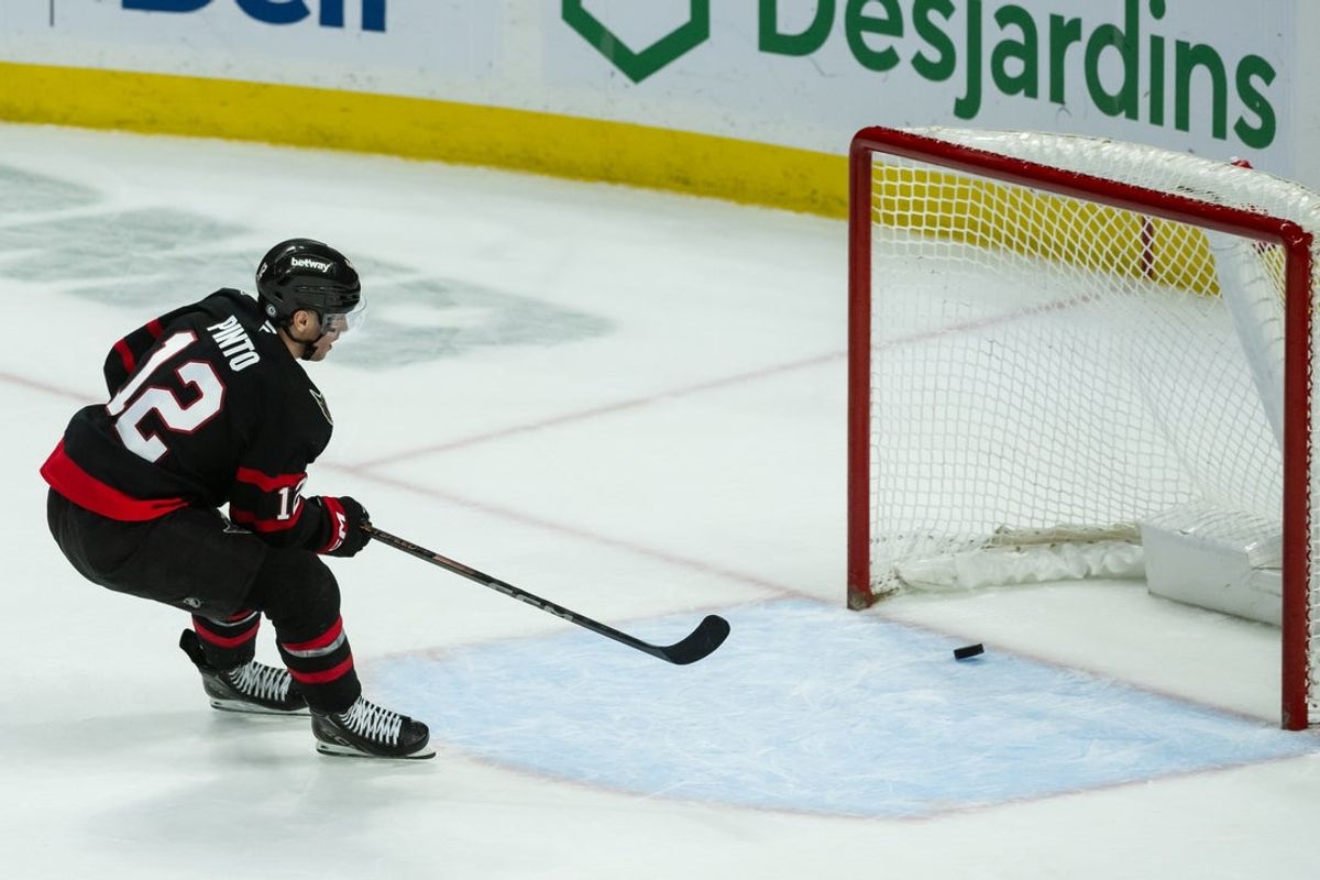 Apr 11, 2025; Ottawa, Ontario, CAN; Ottawa Senators center Shane Pinto (12) scores an empty net goal in the third period to seal the win against the Montreal Canadiens at the Canadian Tire Centre. Mandatory Credit: Marc DesRosiers-Imagn Images