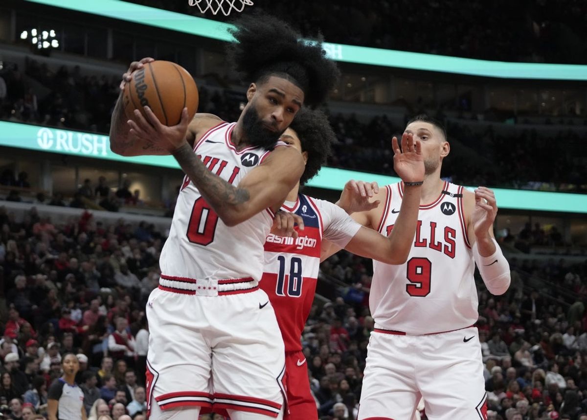 Apr 11, 2025; Chicago, Illinois, USA; Washington Wizards forward Kyshawn George (18) defends Chicago Bulls guard Coby White (0) during the second half at United Center. Mandatory Credit: David Banks-Imagn Images